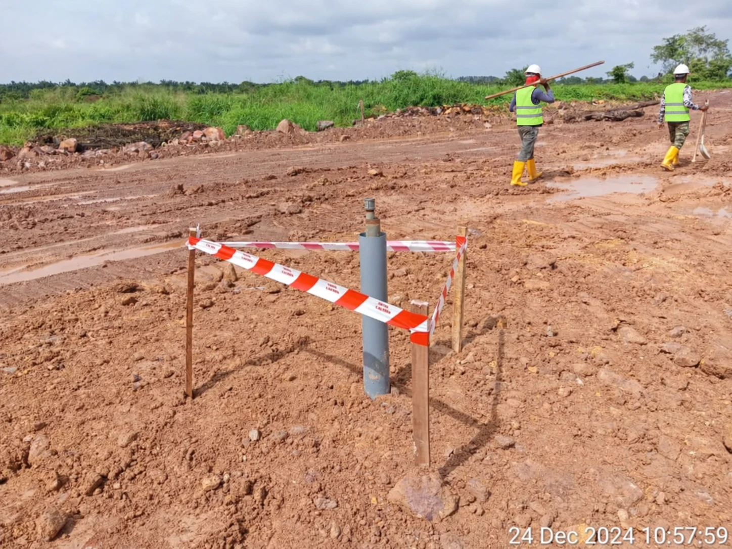 Settlement monitoring point protected by barrier tape on an earthwork site