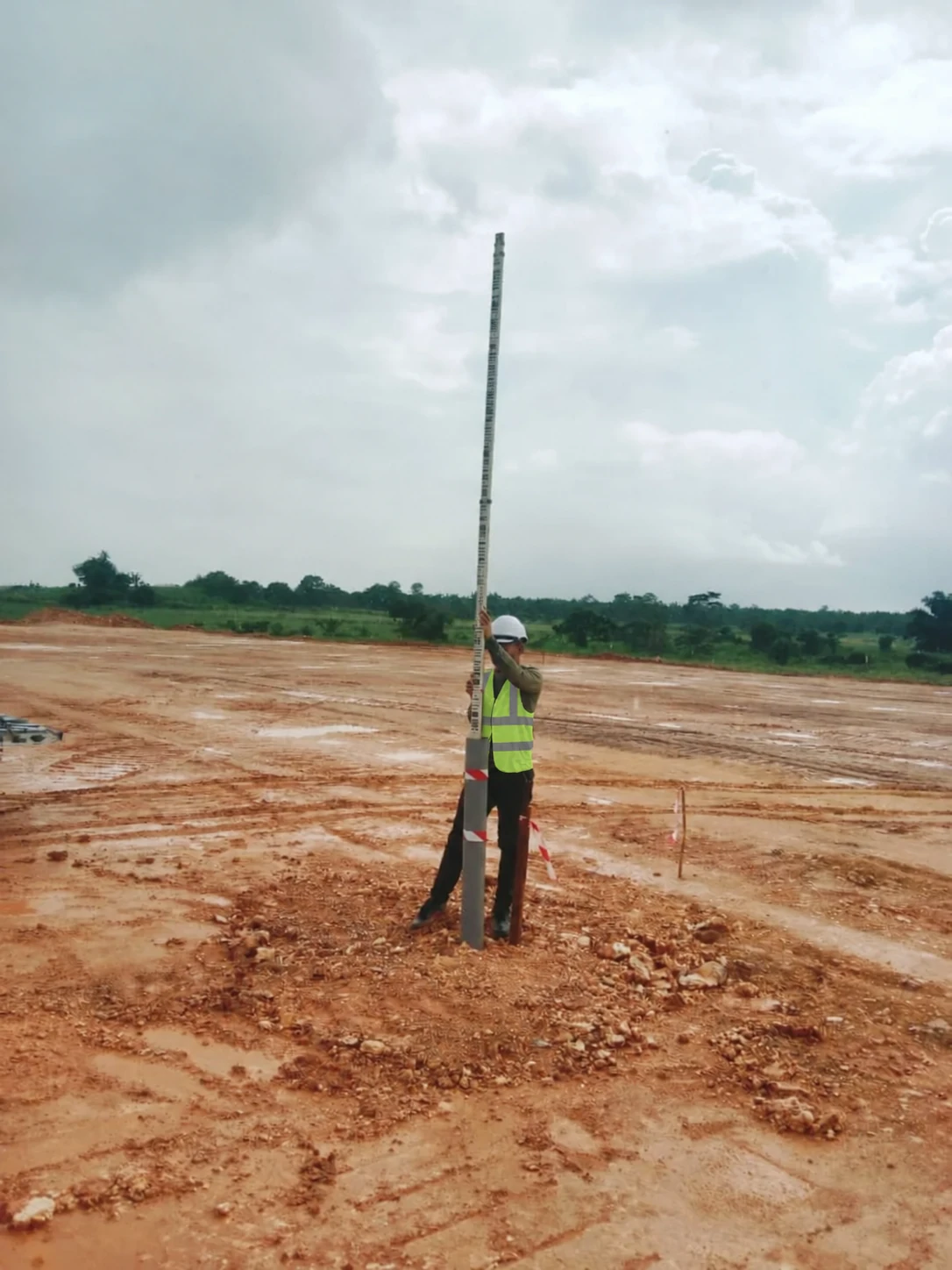 Survey instrument on a tripod at an earthwork monitoring site